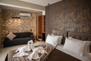 a bedroom with a bed with a swan on it at Alkioni Boutique Hotel in Pýli