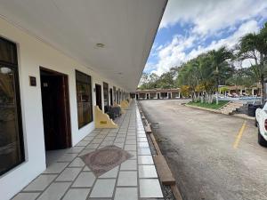 a hallway of a building next to a pool at Hotel Wilson Upala in Upala