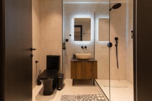 a bathroom with a sink and a toilet and a mirror at Alkioni Boutique Hotel in Pýli +31 photos