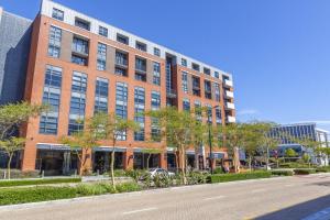 a large brick building with a street in front of it at Enzo Stay -The Matrix 505 , Century City in Cape Town