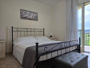 a bedroom with a bed and a large window at Villa Sara in Floridia +15 photos
