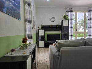 a living room with a couch and a fireplace at Villa Sara in Floridia