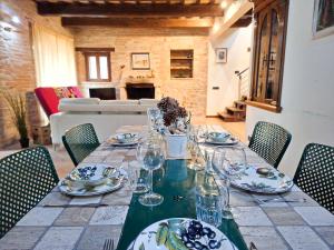 a long table with plates and glasses on it at Villa Santa Maria in Montegiorgio