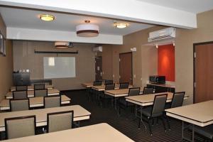 a classroom with tables and chairs and a chalkboard at Holiday Inn Express Pittsburgh - Munhall by IHG in Munhall