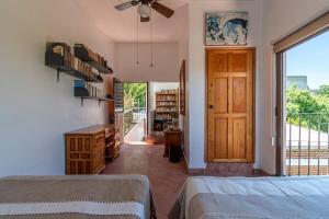 a bedroom with two beds and a sliding glass door at Quinta Rustica "La Aguacana" in Cuautla Morelos +30 photos