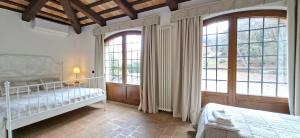 a bedroom with two beds and large windows at Villa Santa Maria in Montegiorgio +29 photos