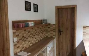 a kitchen with a counter with a tile wall at Chaty Slovensky Raj Veronika in Smižany