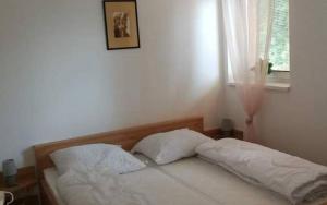 a bed with two pillows in a bedroom with a window at Chaty Slovensky Raj Veronika in Smižany