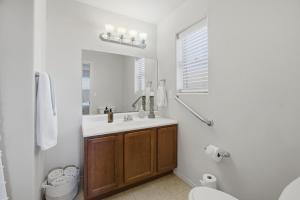 a bathroom with a sink and a toilet and a mirror at The Alturas in Alamogordo +23 photos
