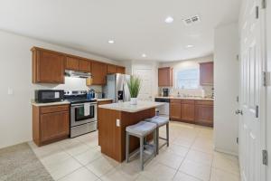 a kitchen with wooden cabinets and a counter top at The Alturas in Alamogordo