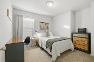 a bedroom with a bed and a desk and a dresser at The Alturas in Alamogordo