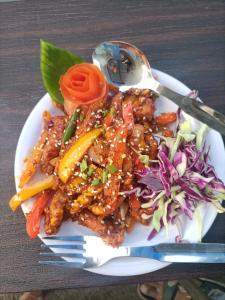 a plate of food on a table with a plate of food at Hotel Rest O ITPL in Bangalore