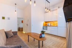 a living room with a couch and a table at Picturesque Old Town Apartment with Charming Balcony in Kaunas