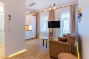 a living room with a couch and a table at Picturesque Old Town Apartment with Charming Balcony in Kaunas