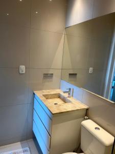 a bathroom with a sink and a toilet at Vizinho dos Parapente - Novo Luxo apartamento in Canoa Quebrada +13 photos