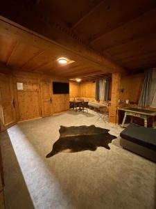 a large room with a large shadow on the floor at FeWo's und Apartment's Blaues Haus in Davos