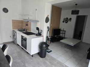 a kitchen with a sink and a stove top oven at Le cocon de mag in Miramas