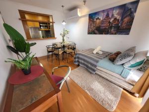 a living room with a bed and a table at Living Suite in El Cerrillo