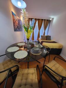 a living room with a table and chairs and a couch at Living Suite in El Cerrillo +18 photos