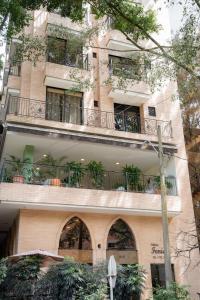 a building with a balcony with plants on it at Edificio Fenicia Loft Laureles in Medellín