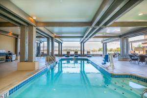 a swimming pool with blue water in a building at The Lodge at Columbia Point in Richland