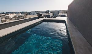 a swimming pool on the roof of a building at Seaside Luxury Home with Rooftop Pool in Birżebbuġa