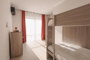 a bedroom with a bunk bed and a large window at Seaside Luxury Home with Rooftop Pool in Birżebbuġa +20 photos