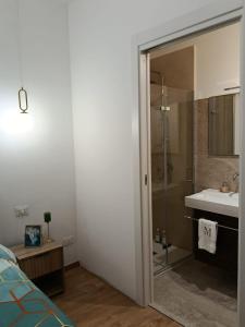 a bathroom with a shower and a sink and a mirror at Vacanze Mariu' in Porto Empedocle