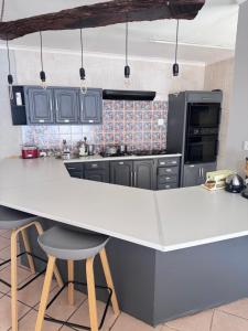 a kitchen with a large white counter top in a kitchen at The Chalant in Tzaneen