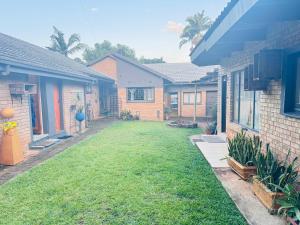 a yard of a house with a grass yard at The Chalant in Tzaneen