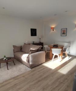 a living room with a couch and a table at Hôtel Le Chalet in Ax-les-Thermes