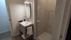 a bathroom with a sink and a shower with a mirror at Hôtel Le Chalet in Ax-les-Thermes +22 photos