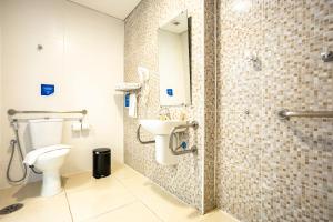 a bathroom with a toilet and a sink at Travel Inn Express Hotels Brás in São Paulo +37 photos