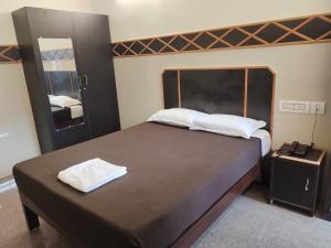 a bedroom with a large bed with two towels on it at Villa La Grande A Couple Friendly Property Near New Bus Stand in Pondicherry