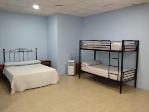 a bedroom with two bunk beds and a fan at Cádiz bahía in Cádiz +19 photos