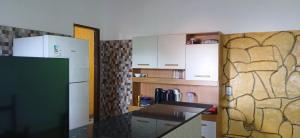 a kitchen with a refrigerator and a counter top at Casa de Gil do Pão in Lençóis