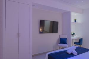 a bedroom with a bed and a tv on a wall at Suite Benvenuti al Sud in Crotone