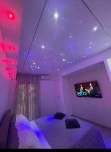 a room with a bed and a tv on the ceiling at Suite Benvenuti al Sud in Crotone +9 photos