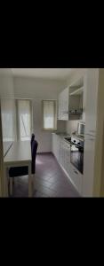 a kitchen with white cabinets and a table and a table and a tableablish at Suite Benvenuti al Sud in Crotone