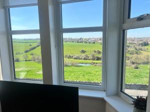 a window with a view of a green field at Upper Valley View in Keynsham