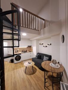 a living room with a couch and a table at ApartmánPohoda in Opava