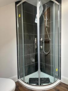 a shower with a glass door in a bathroom at Upper Valley View in Keynsham