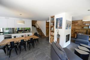 a kitchen and living room with a wooden table and chairs at Chamonix Balcons du Mont Blanc in Chamonix-Mont-Blanc