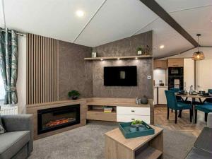 a living room with a couch and a fireplace at Jackson Lodge - Primrose in Malton +6 photos