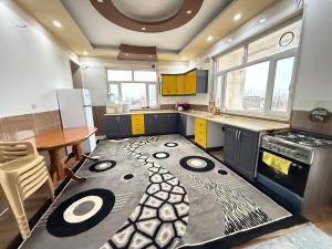 a kitchen with a large rug on the floor at Happy farm in Erbil