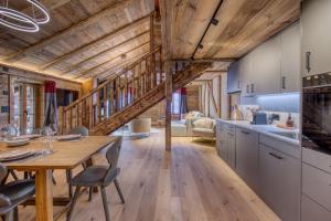 a kitchen and dining room with a wooden ceiling at Central High-End Duplexes, Sauna and Stove in Champéry +52 photos