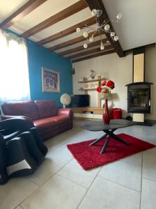 a living room with a couch and a table at Maison de Nathony in Maisons-en-Champagne +25 photos