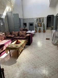 a large living room with couches and tables at Cosy Riad Cœur Medina in Rabat +23 photos
