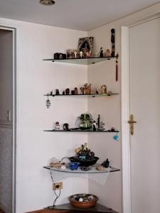 a corner of a room with shelves on the wall at En lo de dan V in Buenos Aires