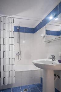 a bathroom with a sink and a shower and a tub at DOMES APARTMENTS in Kallithea Halkidikis +60 photos